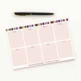 Eras Weekly planner sheet with colorful border and pen on a white background
