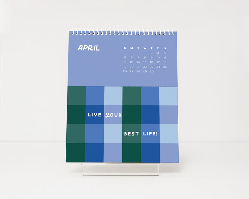 Calendar with blue and green checkered pattern and motivational text on a white background