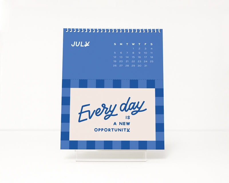Blue checkerboard design calendar with motivational quote on a white background