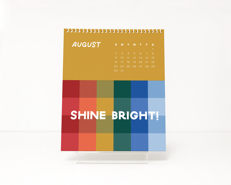 Colorful monthly calendar with 'Shine Bright!' text on a white background