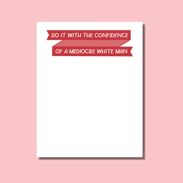 Notepad with humorous feminist quote on a pink background