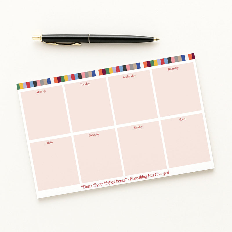Eras Weekly planner sheet with colorful border and pen on a white background